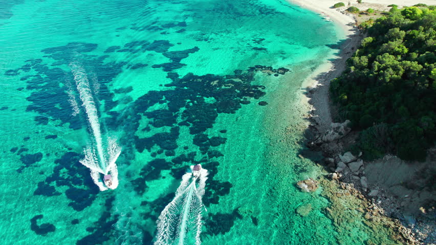 Aerial view of speedboats in crystal clear water near Marathonisi Island, Zakynthos, Greece. Marathon island beautiful turquoise sea water, Zante, Ionian sea.