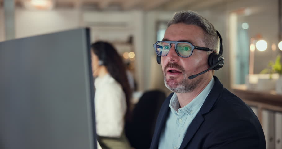 Callcenter agent, computer and man consulting with advice, lead generation or help desk worker with sales. Phone call, telecom office and customer support consultant with deal info at service agency.