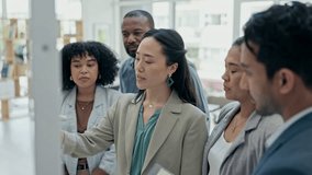 Asian woman, coach and writing on glass board in team brainstorming for schedule planning at office. Female person coaching or training staff on sticky note for strategy or project plan at workplace - Powered by Shutterstock - Get 15% off with code: PIKWIZARD15