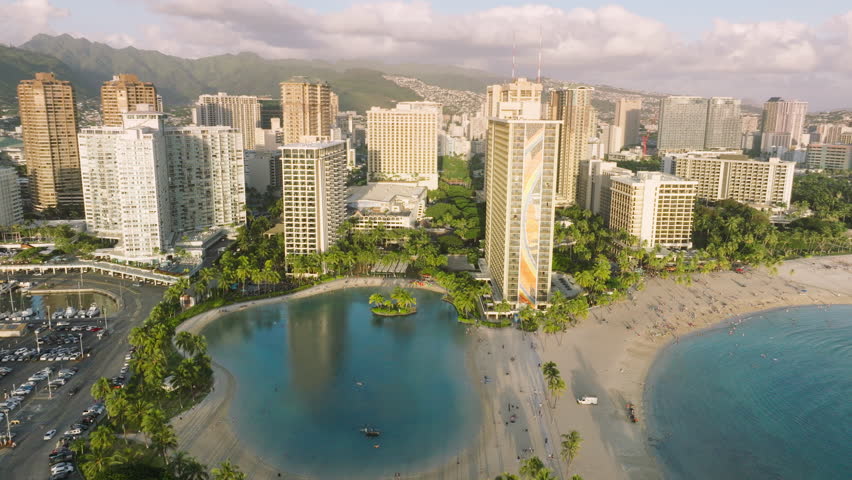 Cinematic aerial modern cityscape drone view at water. Waikiki beach on sunny summer sunset with blue sky. Tourism and travel business 4K footage. Hawaii vacation shot, USA. Modern resorts and hotels Royalty-Free Stock Footage #1105952671