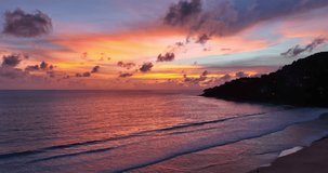 .Drones take pictures of the beautiful sky by the beach in stunning sunset..colorful sky in sunset above the sea video 4K. Nature video High quality footage. .Scene of romantic sky sunset background..