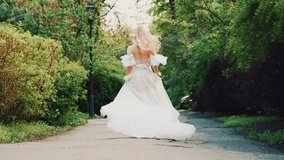 happy woman running on road waiting love, long flowing blonde hair white boho style dress train fly in wind. Cute fantasy girl princess bride back rear view. Summer nature green trees wedding day 4k - Powered by Shutterstock - Get 15% off with code: PIKWIZARD15