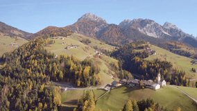 4K aerial - a bird's eye view video (Ultra High Definition) of Dlijia Da Curt Catholic church, Mareo, Province of Bolzano - South Tyrol, Italy, Europe. Stunning morning scene of Dolomite Alps.