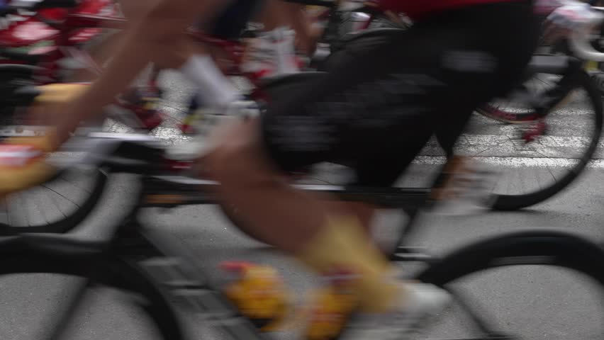 The Dance of the Wheels: A Glimpse of the Moving Peloton during the Tour de France Royalty-Free Stock Footage #1105962453