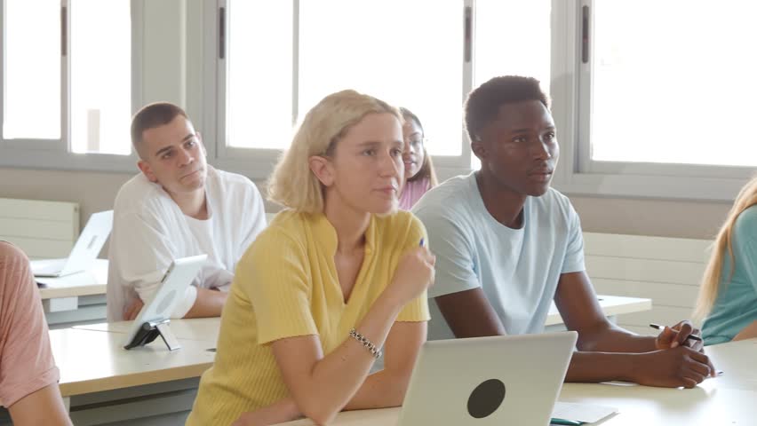 Group of diverse teen students in class listening to the lesson. High school, back to school Royalty-Free Stock Footage #1105962825