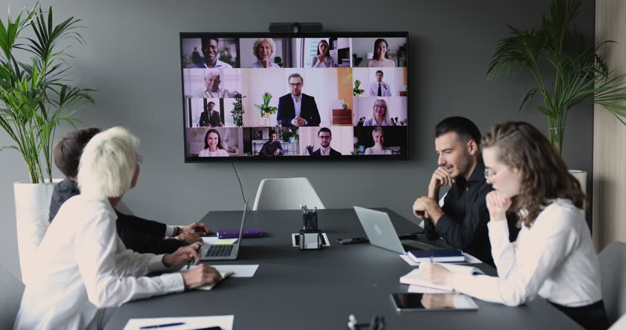 Group of interns watching educating training, learning webinar in conference room, sitting at meeting table, listening to coach speaking from electronic display, using remote internet connection Royalty-Free Stock Footage #1105962991