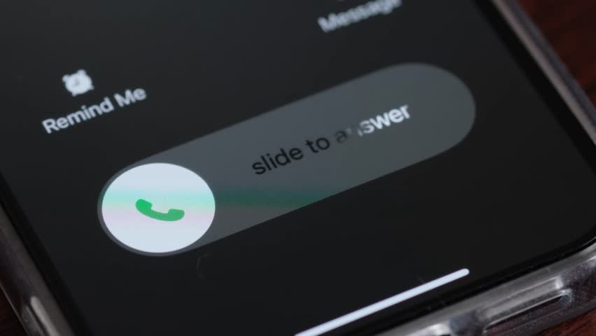 Macro video of an incoming call on a mobile phone. Pick up or reject a call on your smartphone Royalty-Free Stock Footage #1105963505