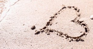 Drawn heart on beach sand was washed by wave from sea 4k movie