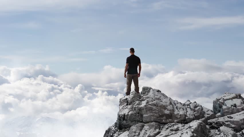 Adventurous Man Standing on top of Mountain Cliff. Extreme Adventure Composite. 3d Rendering Peak. Background Aerial Image from BC, Canada.