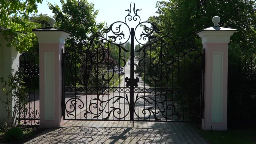 Forged iron gates of the fence Church of St. Nicholas the Wonderworker in Darino with religious symbols