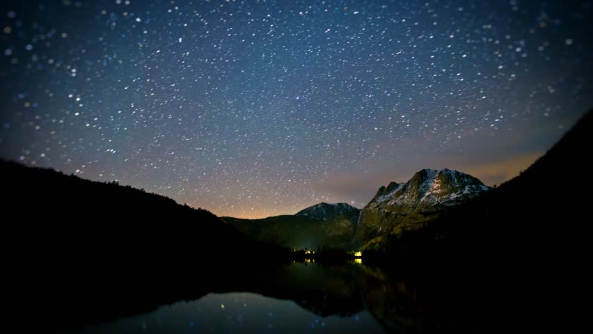 Amazing time-lapse of the night sky with the stars being reflected in a lake. Royalty-Free Stock Footage #1105978497