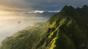 Cinematic Hawaii nature landscapes at golden sunrise. Scenic Oahu coast with beautiful ridges of volcanic mountains. Incredible scenery of green and weird-shaped peaks over ocean coast.Kualoa Ranch 4K - Powered by Shutterstock - Get 15% off with code: PIKWIZARD15