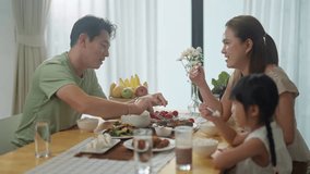 asian happy family spend time have breakfast or dinner on table together at sunlight.Little kid daughter enjoy eat yummy food with father,asian mother.asia family day meet talk at home - Powered by Shutterstock - Get 15% off with code: PIKWIZARD15