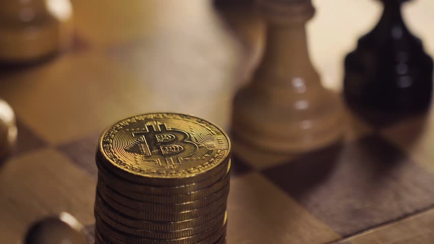Macro person knocks down decentralized bitcoin coins heap and puts chessman horse on currency remainder | Shutterstock HD Video #1105987225