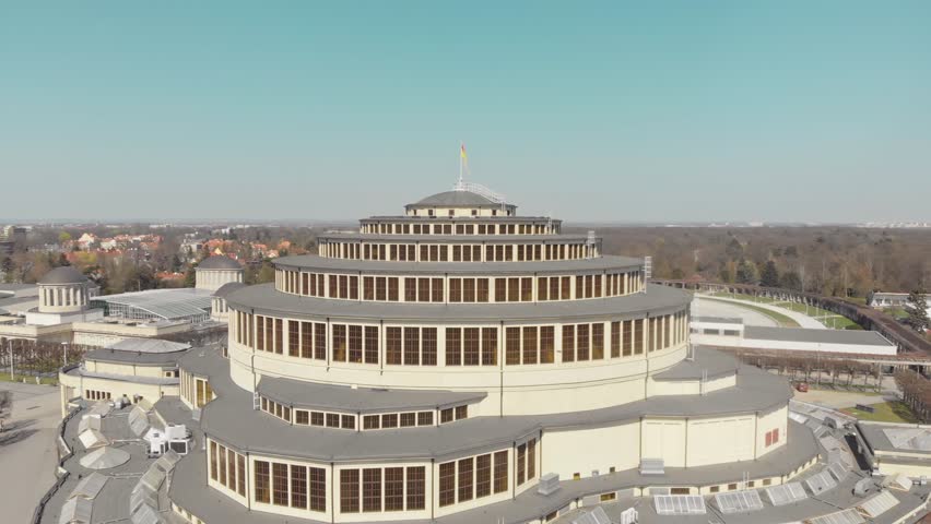 Centennial Hall in Wroclaw, Poland. Aerial footage, Drone shots, Architectural marvel, UNESCO World Heritage Site, Historic landmark, Modernist architecture, Max Berg, Symmetrical, Hala stulecia Royalty-Free Stock Footage #1105987585