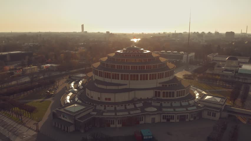 Centennial Hall in Wroclaw, Poland. Aerial footage, Drone shots, Architectural marvel, UNESCO World Heritage Site, Historic landmark, Modernist architecture, Max Berg, Symmetrical, Hala stulecia Royalty-Free Stock Footage #1105987589