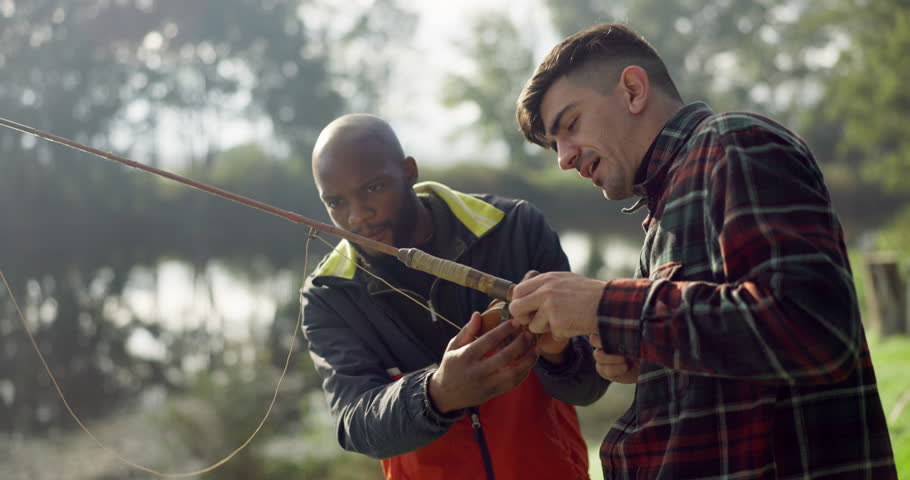 Fishing, lake and friends help in nature on holiday, adventure and vacation together outdoors. Friendship, casting a line and men with rods by river for sports hobby, activity and catching fish Royalty-Free Stock Footage #1105990029