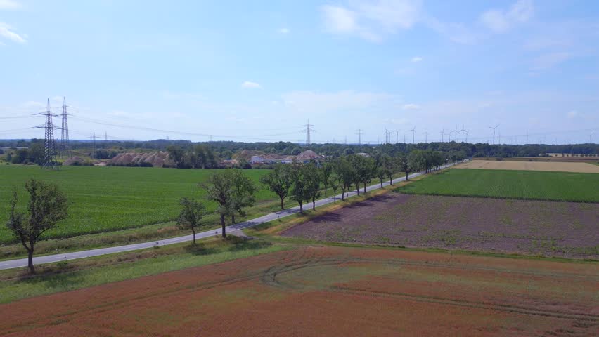 Beautiful aerial top view flight red poppyfield Rural area summer meadow. Brandenburg Havelland Germany 2023. descending drone
4K cinematic.
