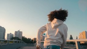 Black woman dancing on the bridge. Shot with RED helium camera in 8K. 