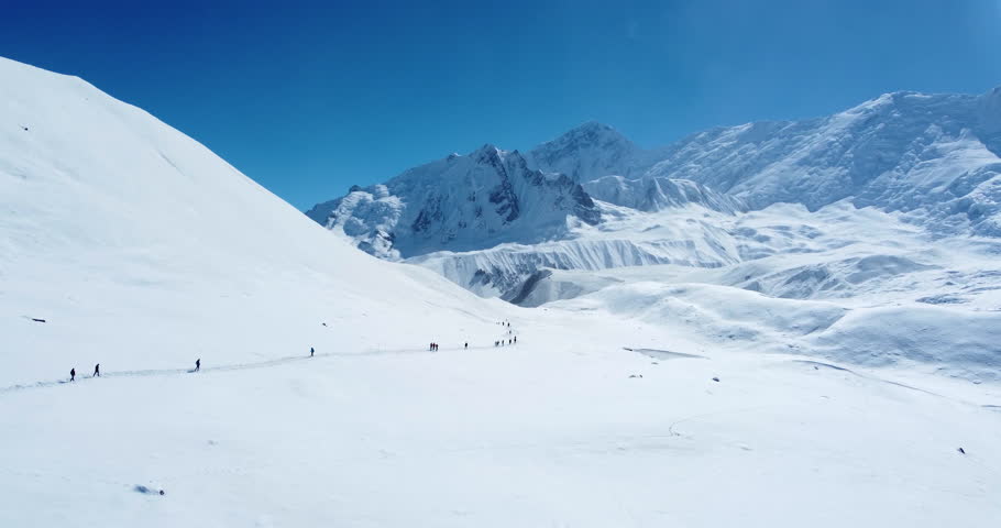 Drone glides around Manang Nepal a snowy land surrounded by mountains. People travel to reach the Annapurna summit. Adventure and peaceful trek 4K | Shutterstock HD Video #1105996061
