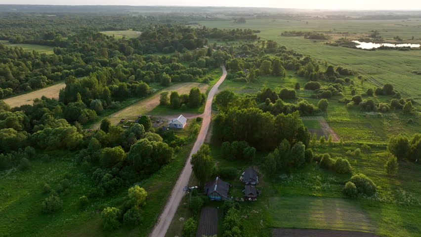 Rural landscape. Country houses in countryside. Village Home in Country. Wooden house in Russian village. Agricultural field with Suburban house. Rural building in countryside. Roofs of village home