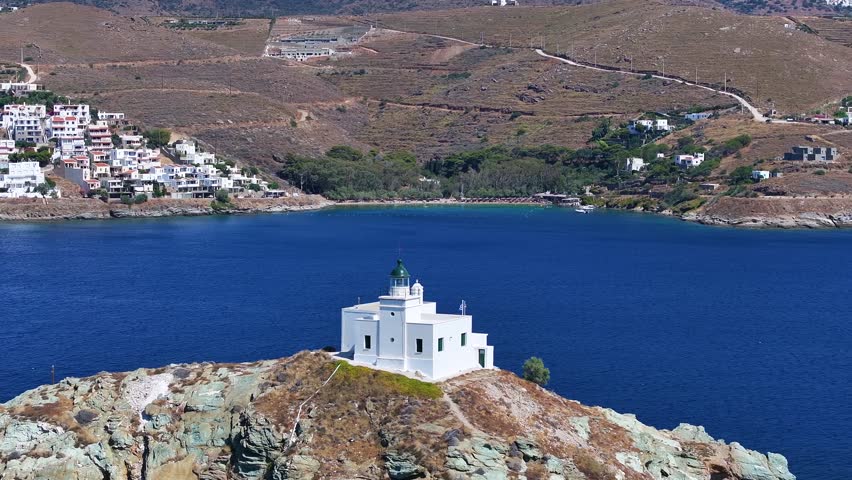 Aerial view of lighthouse and Agios Nikolaos church on a rocky cape at Kea, Tzia, Greece, popular tourist summer destination at the Cyclades islands