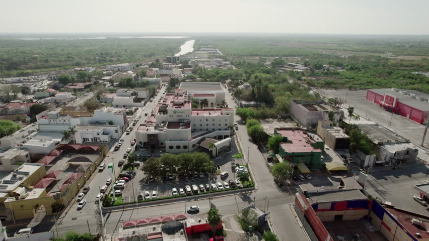 Aerial over residential area in Reynosa, an border city in the northern part of the state of Tamaulipas, in Mexico. Río Bravo, border between Mexico and the U.S. state of Texas. Royalty-Free Stock Footage #1106002253