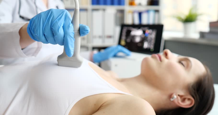 Doctor doing ultrasound examination of breast of patient in clinic 4k movie slow motion Royalty-Free Stock Footage #1106003673