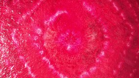 Captivating macro video showcasing the vibrant hues, intricate textures, and mesmerizing details of a sliced half beetroot, captured through a specialized probe lens. Beetroot background. 4K HDR
