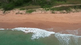 Drone footage. Aerial view of beach as main subject in Philippines. We can see in the video beaitiful waves with recife and beach and jungle on the coast.