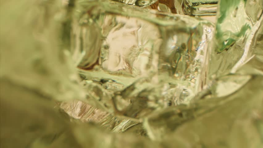 Inside view in ice cubes on cool refreshing soda pop fizzy sugar energy drink. Extreme close up super macro slow motion 1000 fps cold fizzy soda pop energy sugar drink is pouring inside in ice cubes