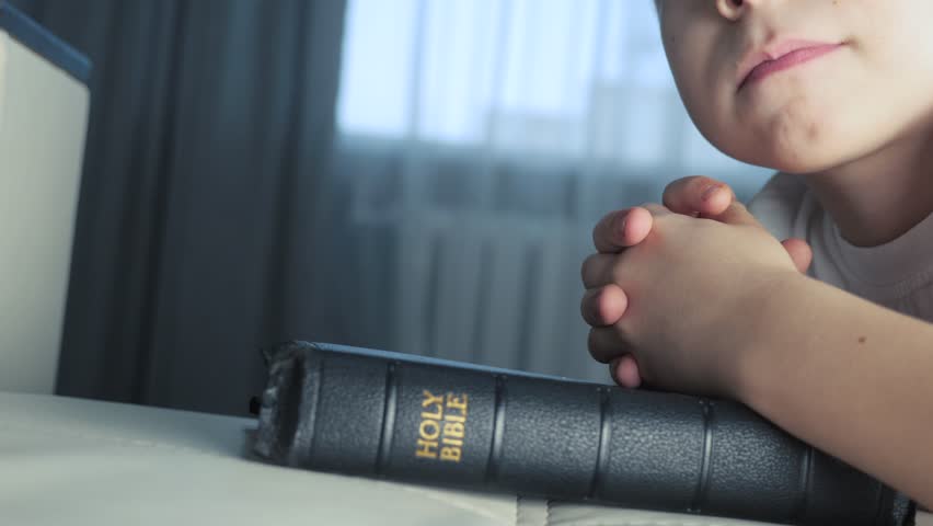 little boy praying bible. religion concept holy book bible. little boy prays at home in the evening lifestyle by the bed on bible Royalty-Free Stock Footage #1106014403