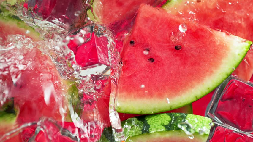 Super Slow Motion Shot of Water Wave Splashing on Watermelon Slices and Ice Cubes at 1000fps.