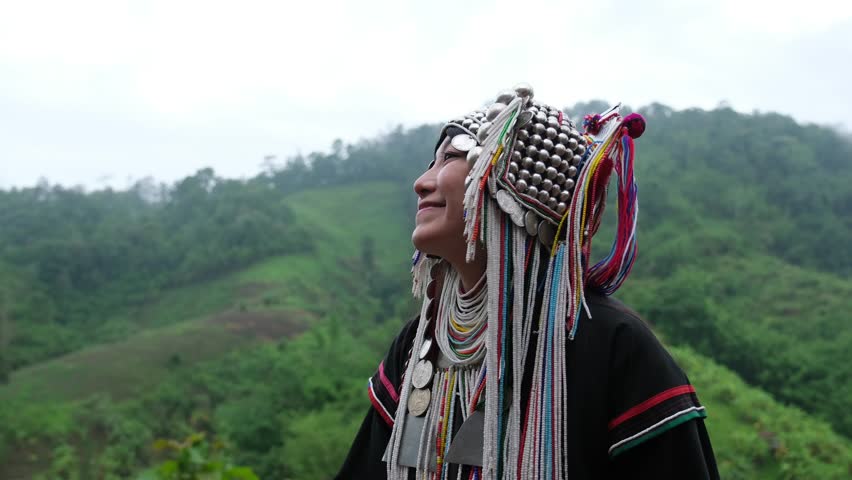 Slow motion of a young woman in Akha traditional dress looking at a beautiful nature