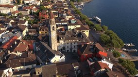 Ascona, Switzerland - September 18 2022: Aerial drone footage of the Ascona town famous for its waterfront promenade and ancient architecture in canton Ticino in Switzerland with a tilt up motion