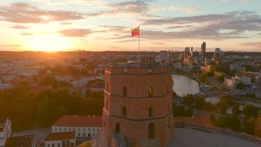 Sunset aerial view of Gediminas Tower, the remaining part of the Upper Castle in Vilnius. Sunset landscape of UNESCO-inscribed Old Town of Vilnius, the heartland of the city, Lithuania. Royalty-Free Stock Footage #1106037021