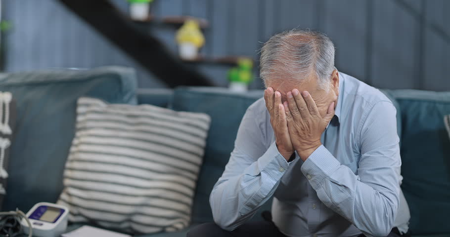 Worried retired old senior man sitting alone on sofa look away feel sorrow abandoned anxiety at home. Unhappy Indian middle aged male grieving think lonely depressed pensive suffering health problems Royalty-Free Stock Footage #1106039343