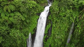 The drone view of Gomblang Waterfall in Banyumas, Central Java, Indonesia. This aerial video was taken on June 5, 2022 by a professional. This video contains view of amazing waterfall in tropical