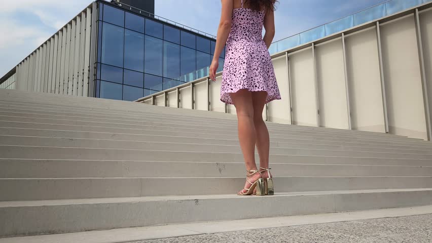 Low angle view of beautiful female legs ascending the stairs
