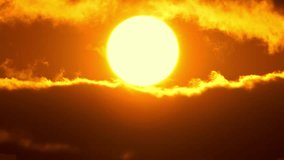 Cinematic sun set at red yellow and orange sky timelapse. Hot summer atmosphere at heat wave. Yellow sun setting at epic golden hour time lapse. Close up view of big round sun disk. - Powered by Shutterstock - Get 15% off with code: PIKWIZARD15