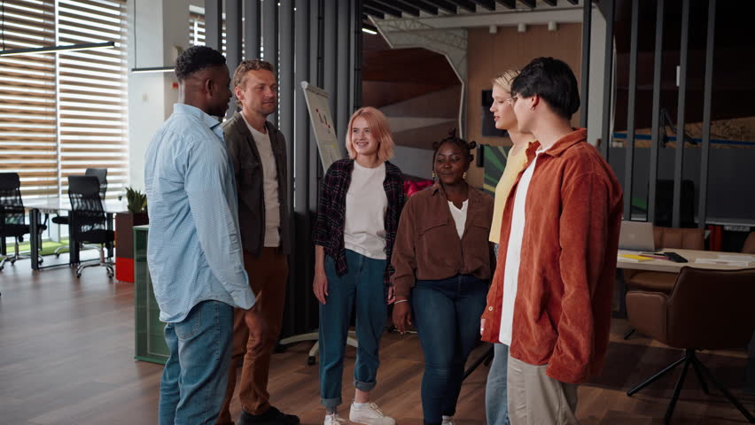 Successful confident diverse team of determined purposeful business men and women, standing with their hands together in a huddle in the lobby of modern office interior. Ppeople. Career. Success Royalty-Free Stock Footage #1106052241