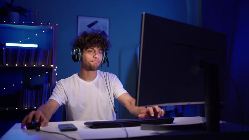 Arabic happy male gamer winning in online video game on computer. The streamer during broadcast Royalty-Free Stock Footage #1106053579