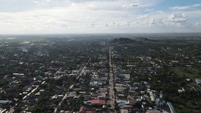 flying over asian city and there is little city traffic on the road, drone footage, cambodia
