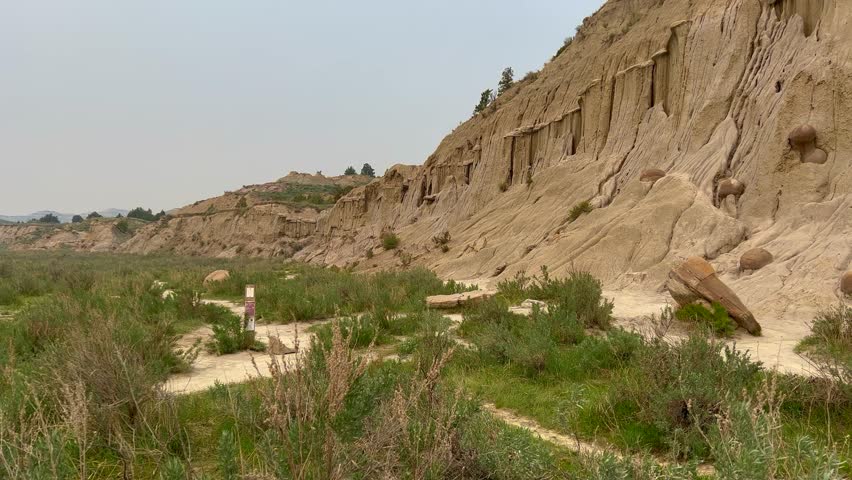 Panning Left on the badlands hills and mountains in the Cannonballs area in the North Unit in  Theodore Roosevelt National Park in North Dakota.