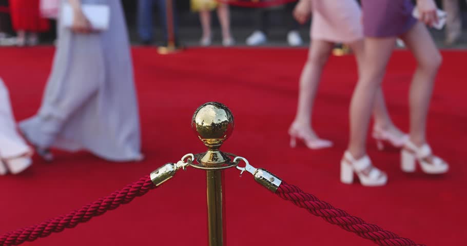 Red carpet with ropes and golden barriers on a luxury party entrance, cinema premiere film festival event award gala ceremony, wealthy rich guests arriving, outdoor decoration elements, summer day Royalty-Free Stock Footage #1106057891