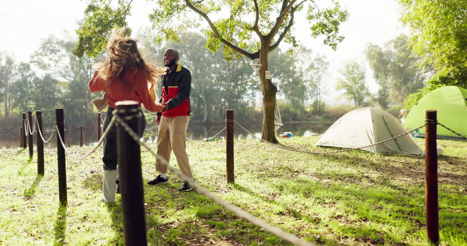 Camping, happy and couple hug in nature walking with tent on outdoor holiday, vacation and adventure, Campsite, traveling and man and woman by lake in forest for bonding, quality time and relax