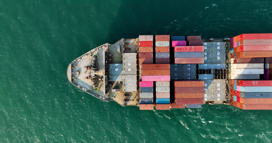 cargo container ship full speed sailing in sea import export goods and distributing products to dealer and consumers across worldwide by container ship Transport 4k video drone point of view  Royalty-Free Stock Footage #1106063553