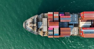 cargo container ship full speed sailing in sea import export goods and distributing products to dealer and consumers across worldwide by container ship Transport 4k video drone point of view 