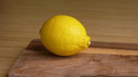 Lemon. 4K video of cutting a lemon with a knife.