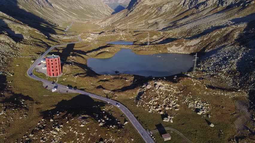 Julier pass, Switzerland: Aerial drone footage of the mountain road on the Julier Pass in Canton Graubunden in the Alps in Switzerland in summer. Shot with a tilt up motion. 